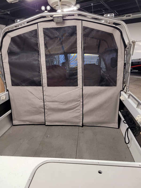 Rear view of North River fishing boat deck with new top designed and installed using new Tuffak polycarbonate by James Boat Fiberglass and Upholstery, Dixon, CA