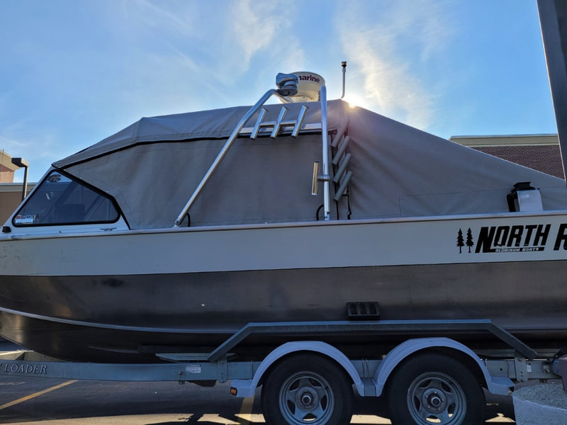 Side view of North River fishing boat deck with new top designed and installed using new Tuffak polycarbonate, covered with removable canvas,  by James Boat Fiberglass and Upholstery, Dixon, CA